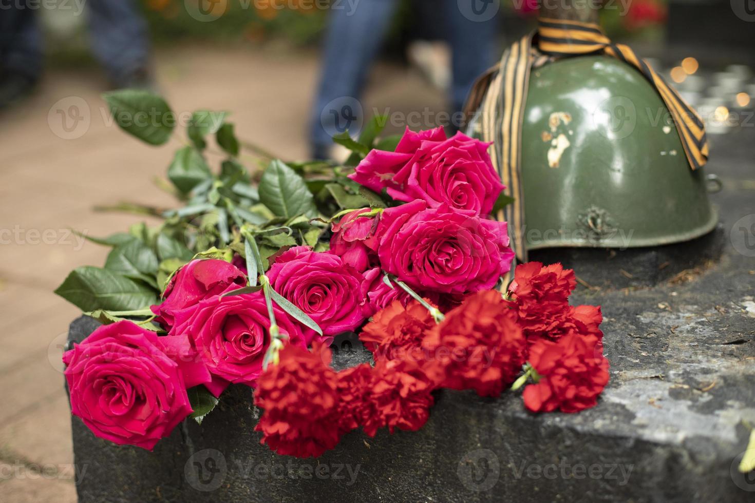 Flowers on grave of soldier. Mass grave in Russia. Burial place. photo