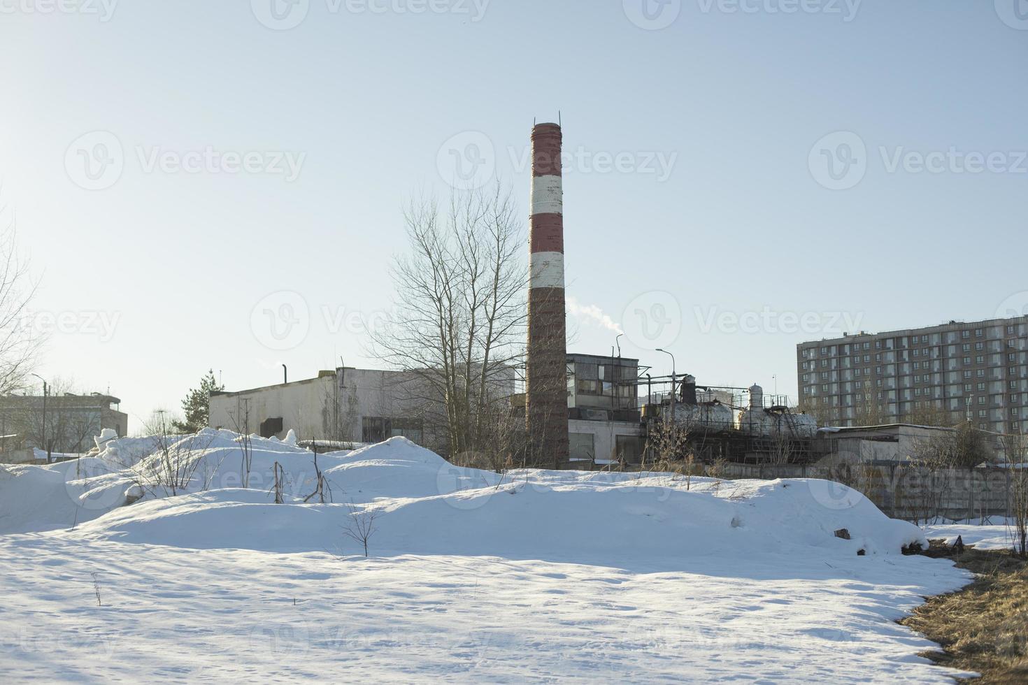 Pipe factory in city. Industrial landscape. Plant in winter. photo