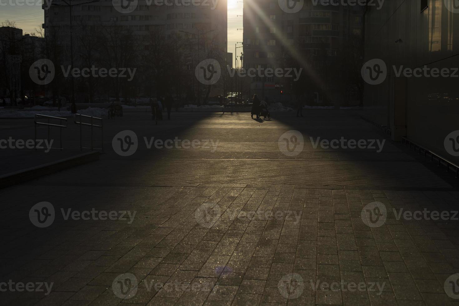 Sunny road. Light in square. Rays shine into camera. photo