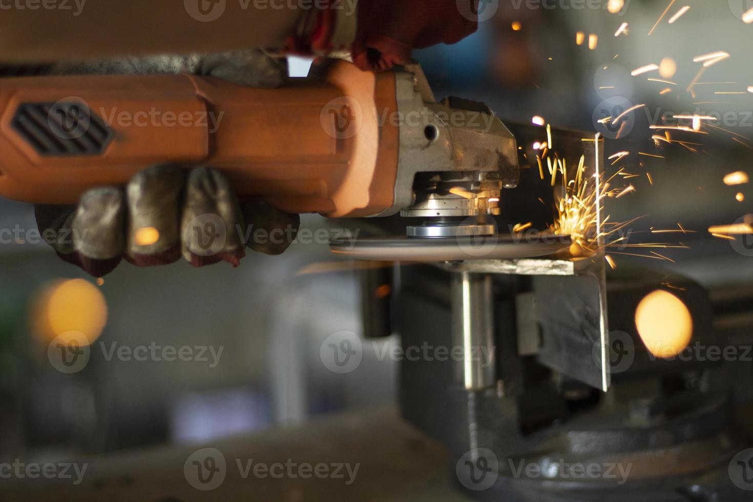 Grinding steel. Caviar from grinder. Circular saw. High speed of disk rotation. Fire from metal. photo