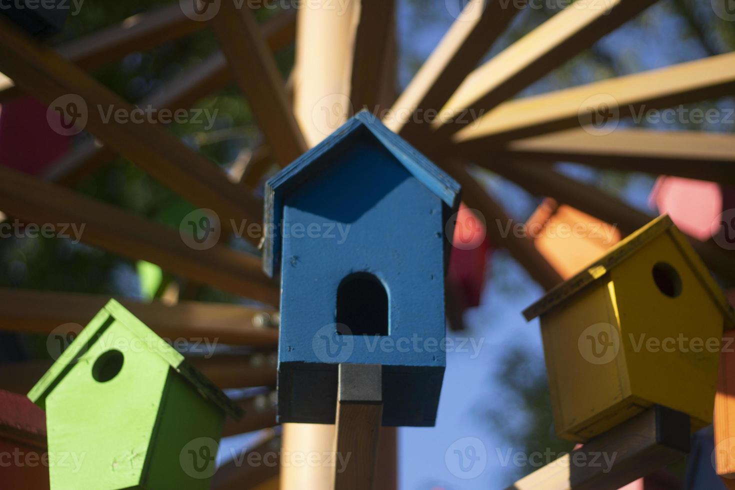 Houses for birds. Colored wooden houses. An element in the park. Art object for animals. photo