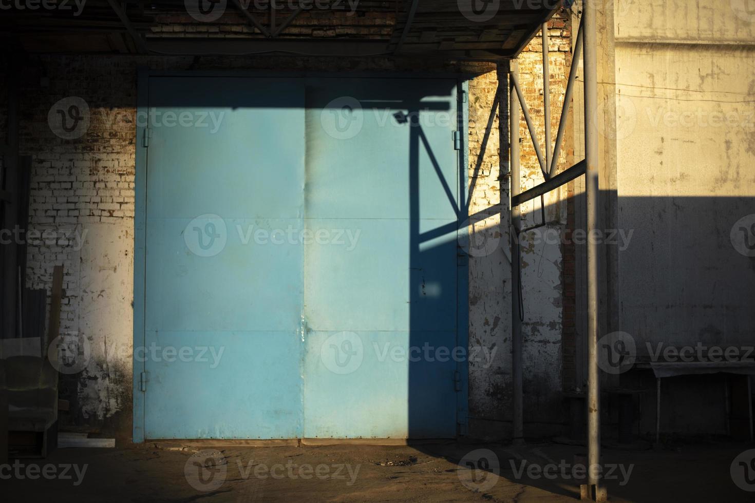 Gate to large garage. Blue gate to warehouse. Industrial zone. photo