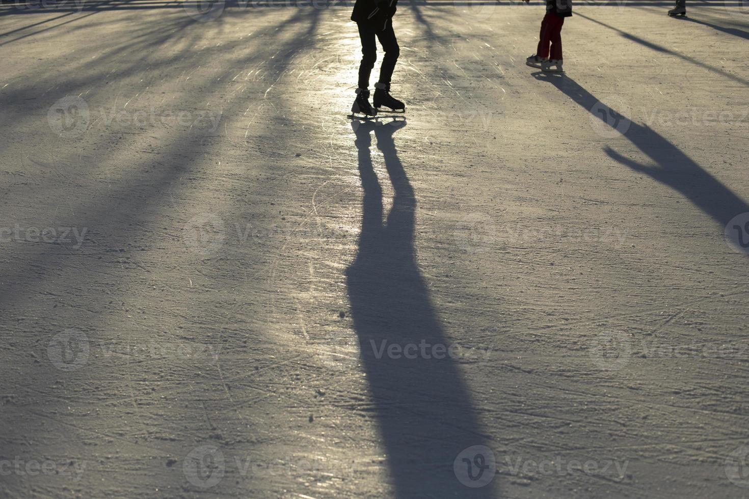 Ice skating. Sliding on ice. Shadow of man on skates. photo