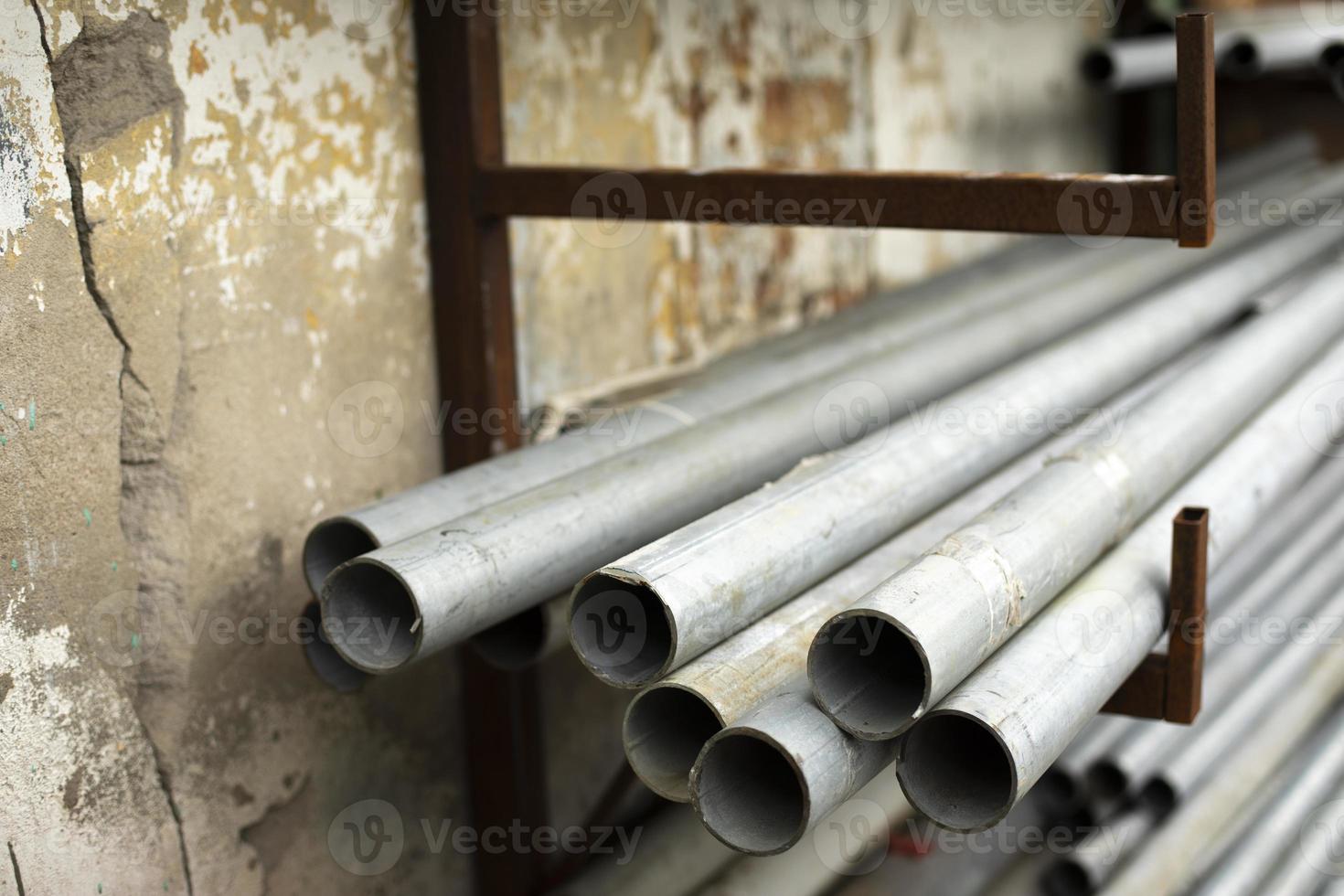 Steel pipes are in stock. Lots of cut metal pipes. Warehouse details. photo