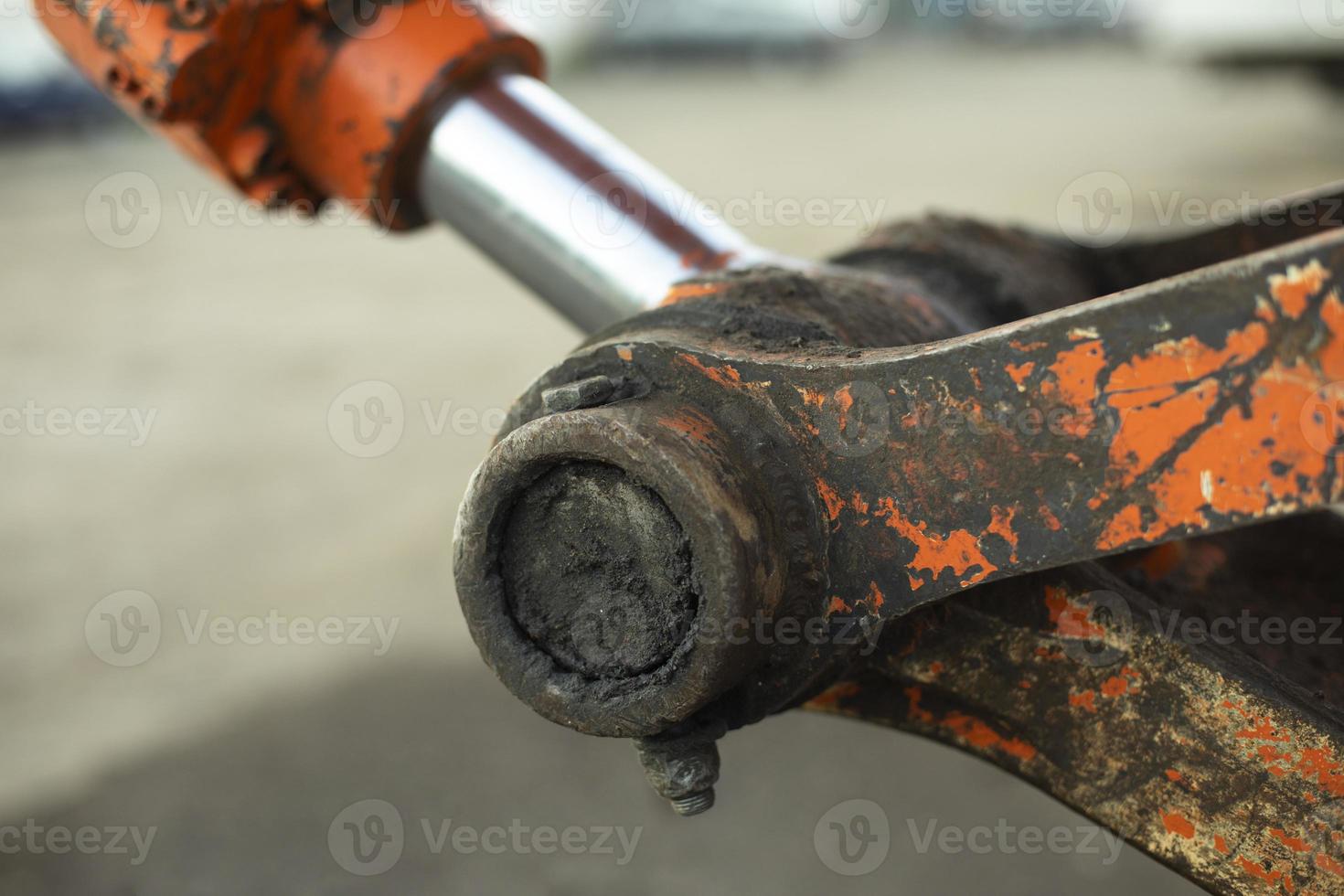 Hydraulic holder. Tractor parts. Heavy machinery up close. Orange equipment. photo