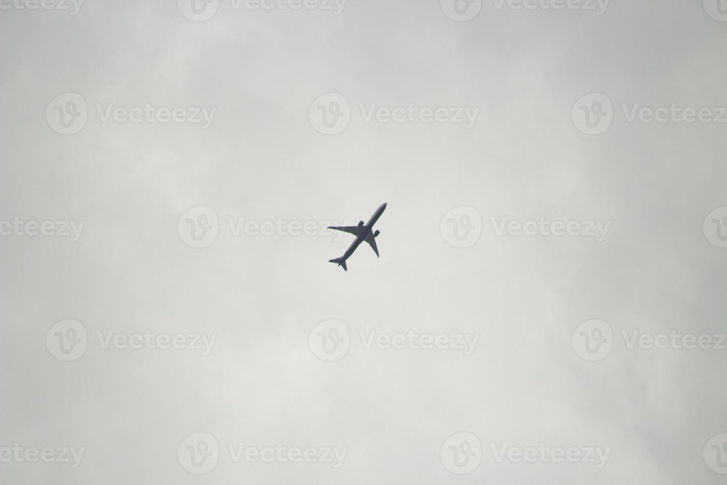 Flight details. Small plane in gray sky. photo