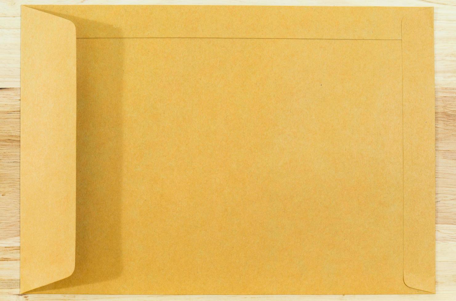 Brown envelope on wood floors photo