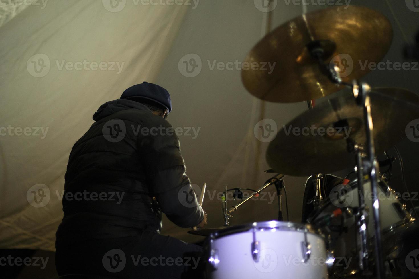 Drummer at music festival. African-American beats drums. photo