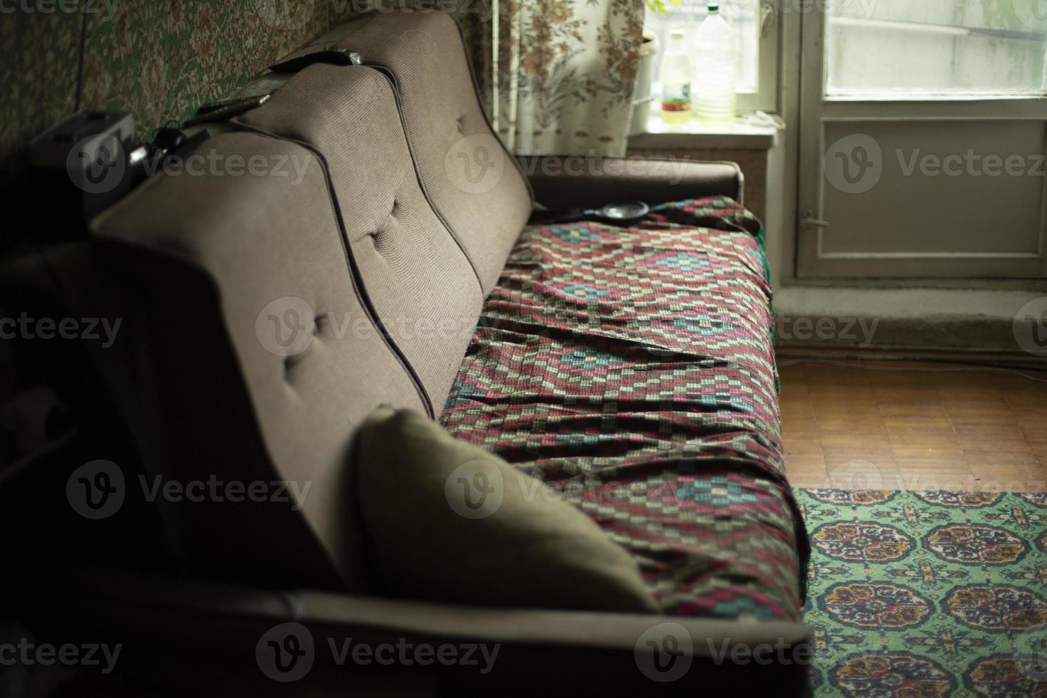 Old sofa in room. Furniture in apartment. photo