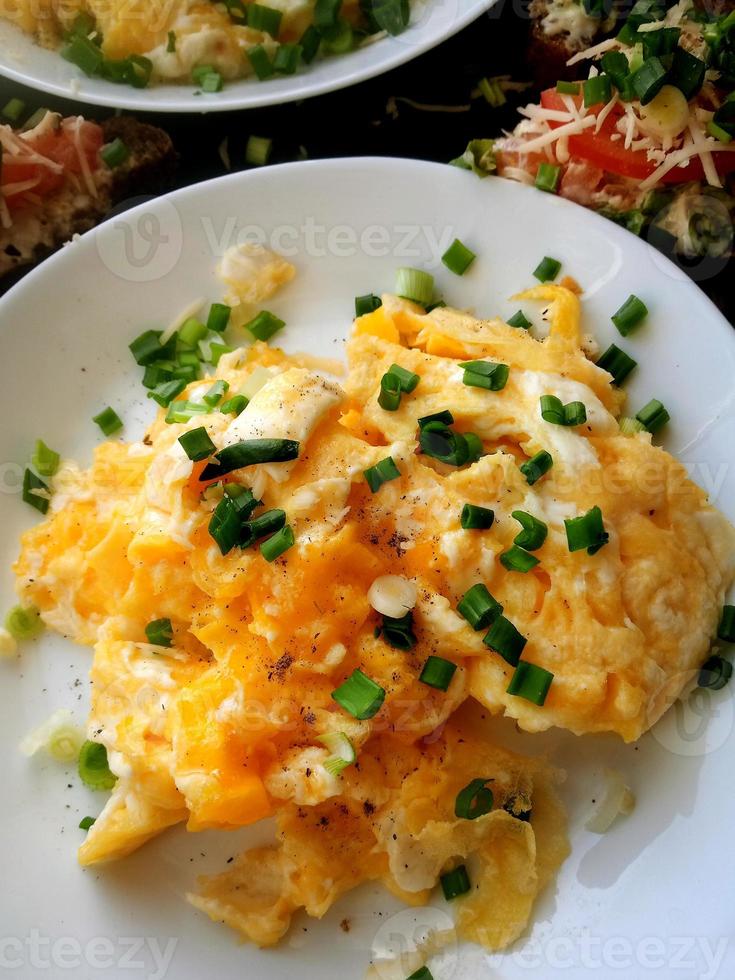 Scramble of eggs, sprinkled with green onions. photo