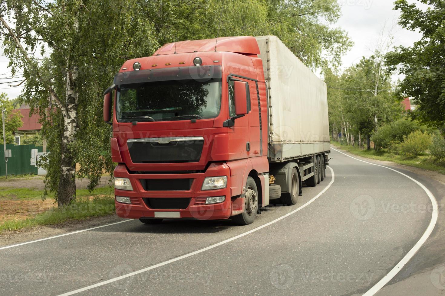 Truck on road. Transportation of goods. Big car on narrow highway. photo