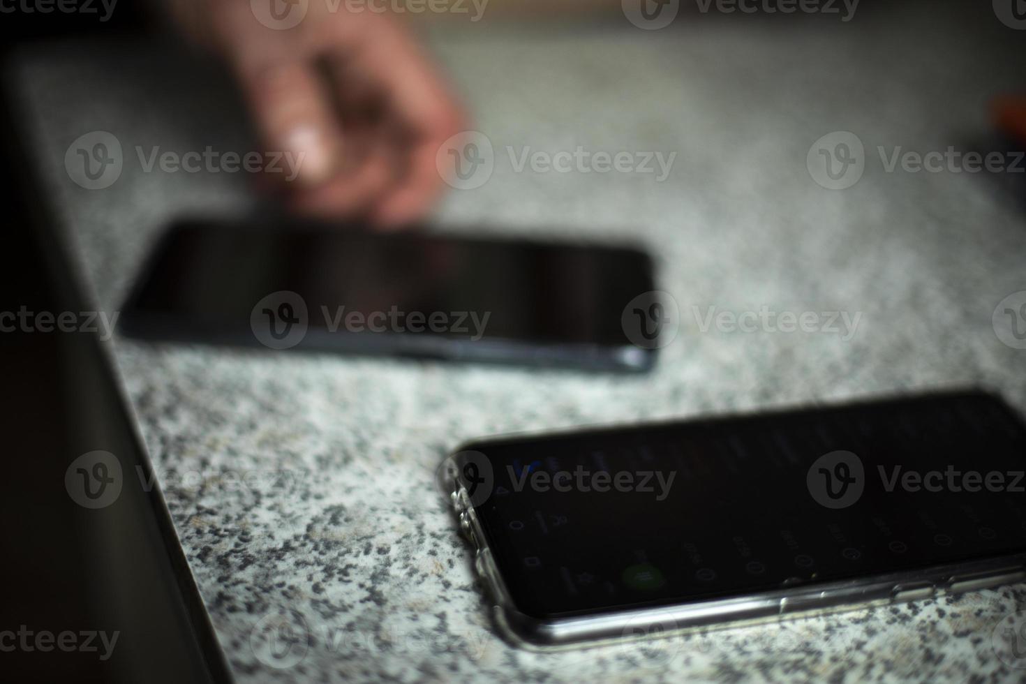 Smartphone on table. Two black phones. photo