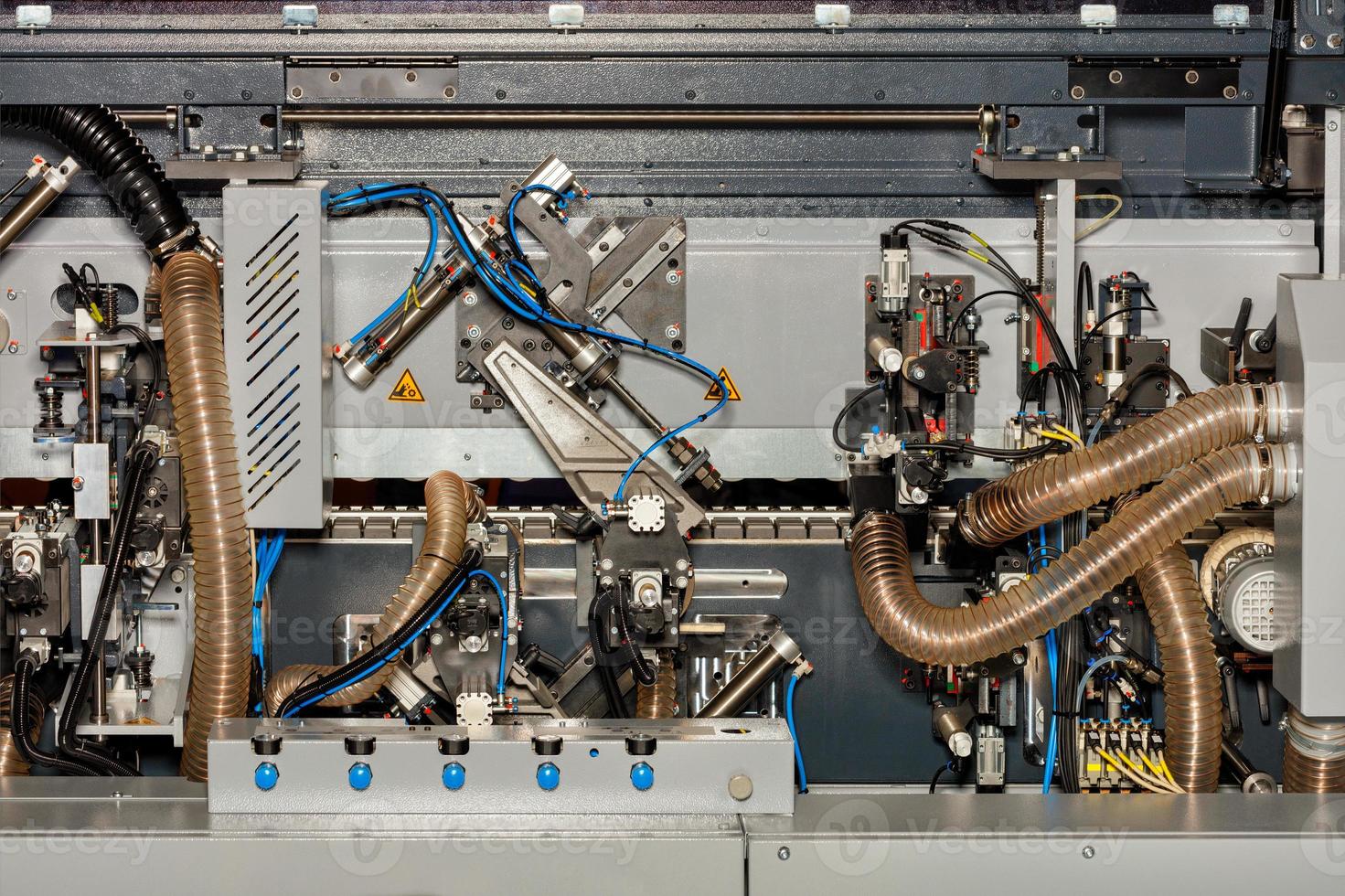 A fragment of the internal system of a modern woodworking machine with mechanisms for controlling and removing sawdust. photo