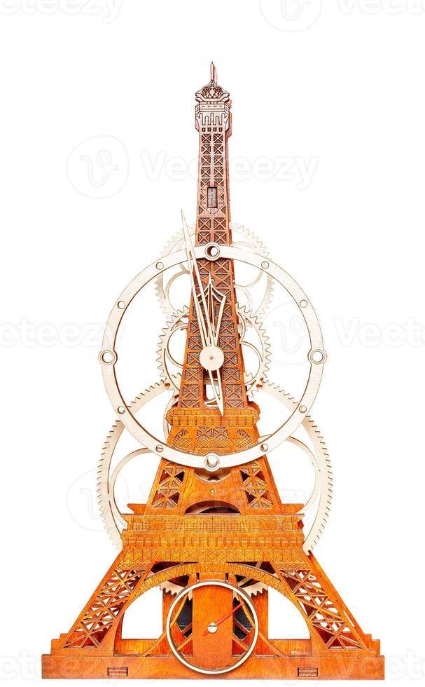 Model of handmade wooden wall clock in the form of an eiffel tower. The image is isolated on a white background. photo