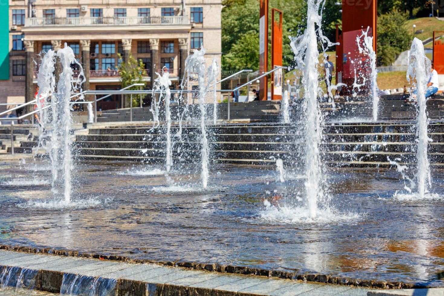 A beautiful ensemble of fountains on a clear sunny day in the city square. photo
