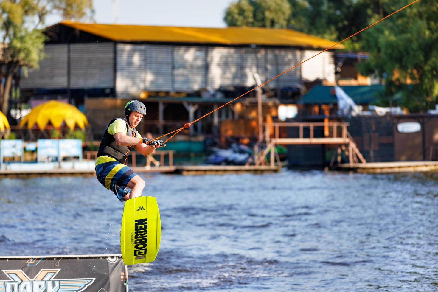 A middle aged man athlete jumps from a springboard on a water board on a summer day. 06.19.1922. Kyiv. Ukraine. photo
