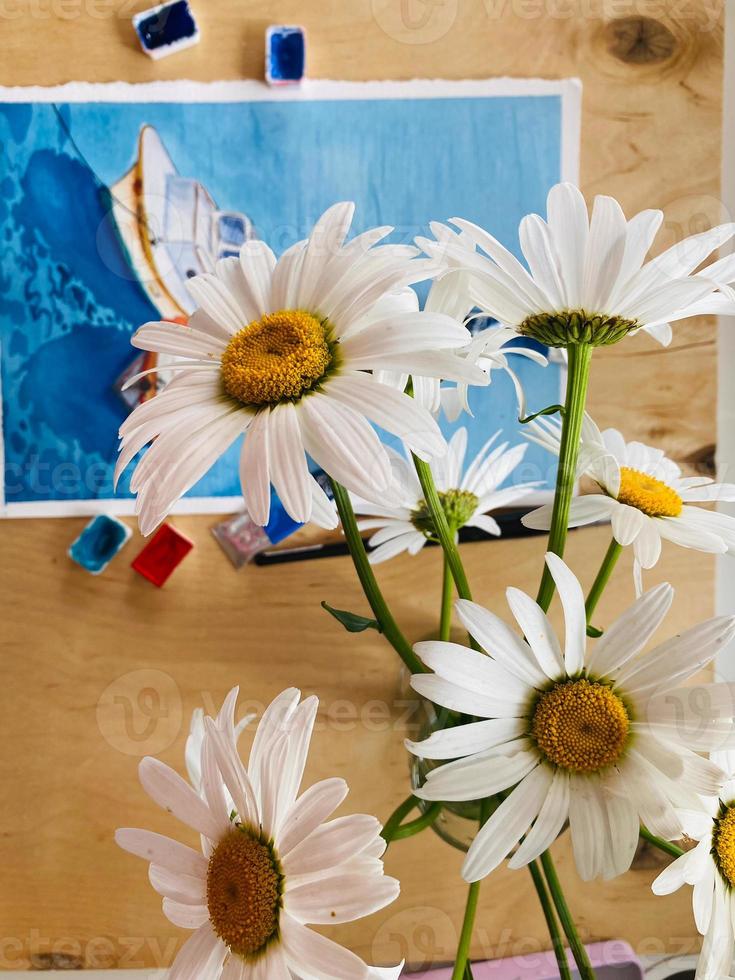 close up of daisy flowers on table and blue background. beautiful flower. photo