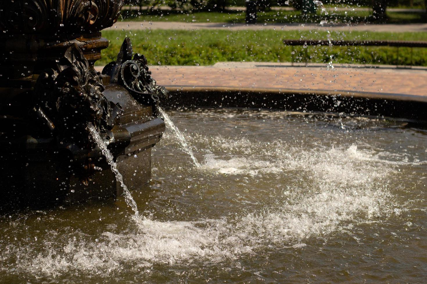 Part of the city fountain with water splashes. photo