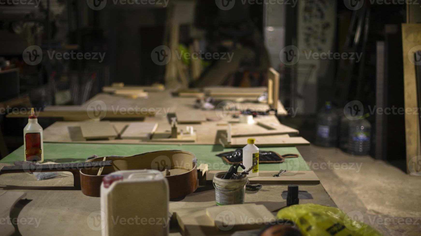 Carpentry workshop in detail. Interior of wood workshop. Items on table. photo