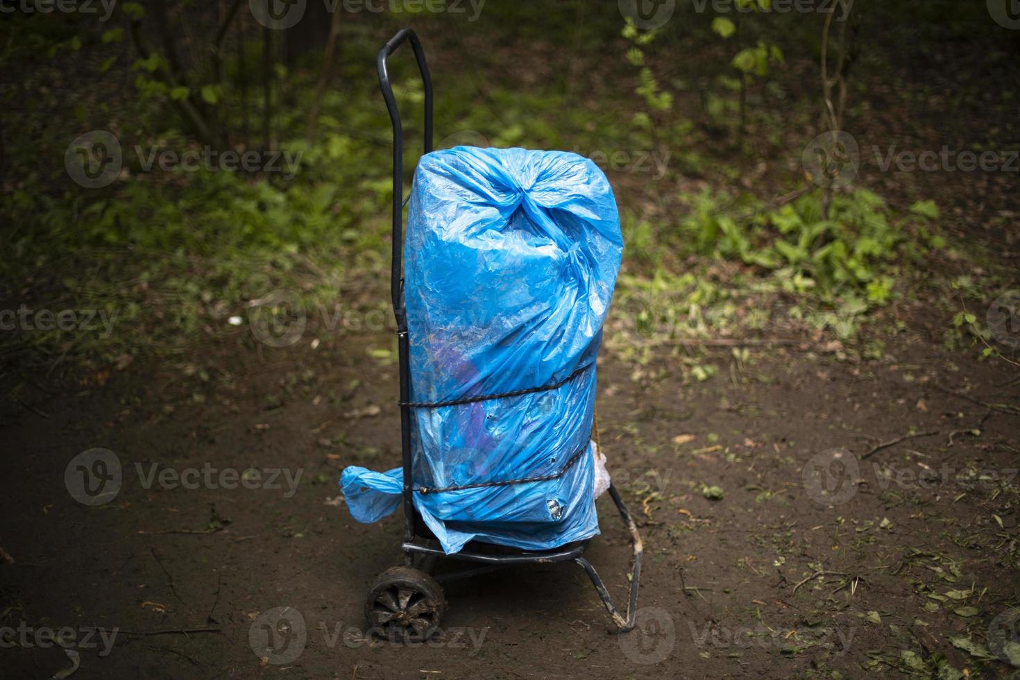 Cart with cargo. Forgotten bag. Blue package. photo