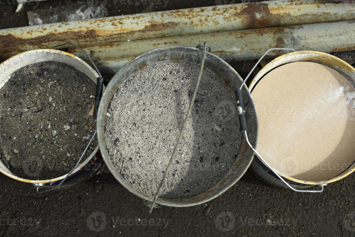 Buckets of ashes. Ash in jar. Ashes in container. photo