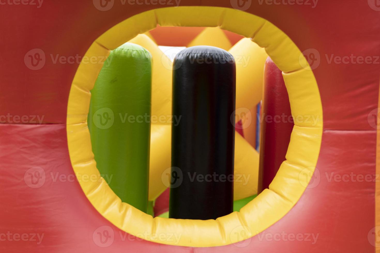 Obstacle course is red. Inflatable amusement park. Attraction for children. photo