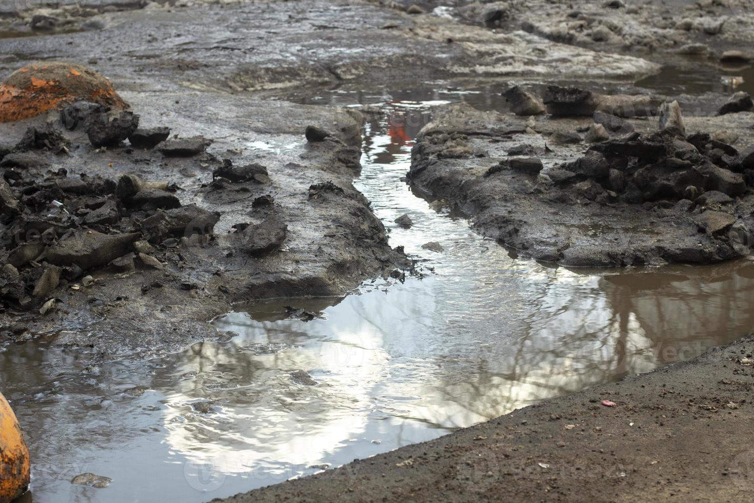 Dirt on road. Road is in muddy snow. photo