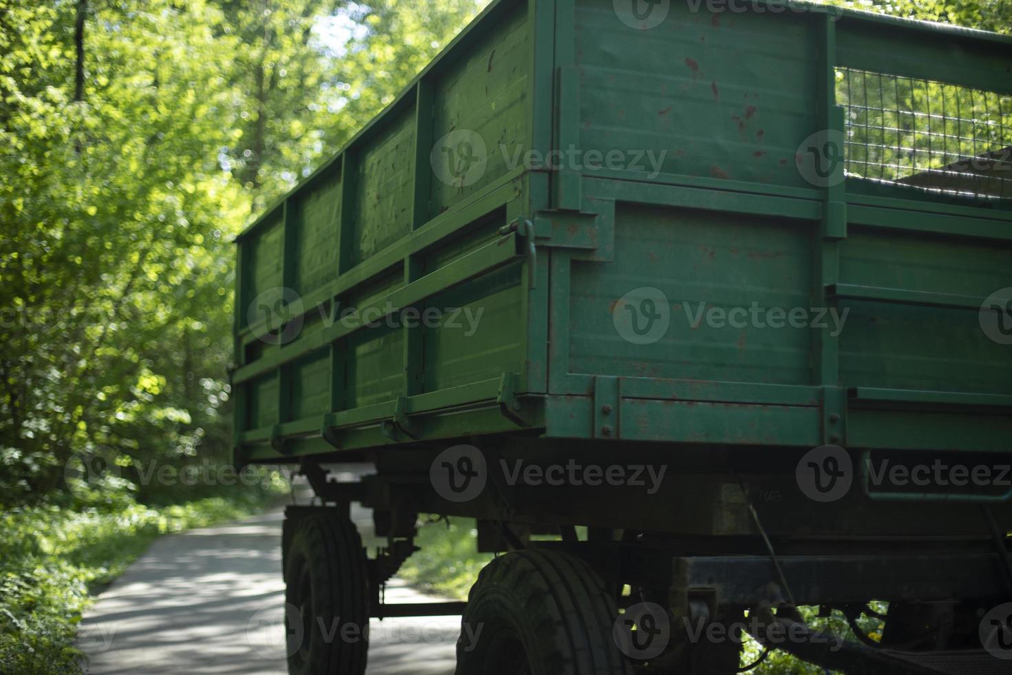 Green tractor trailer. Cart on wheels. Side of trailer. Body of transport. photo