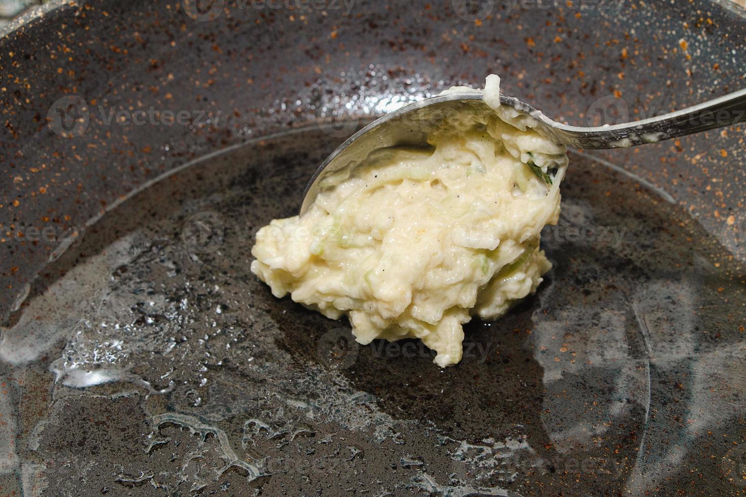 Recipe for zucchini fritters. Step 4 - Putting dough on hot pan with oil. photo