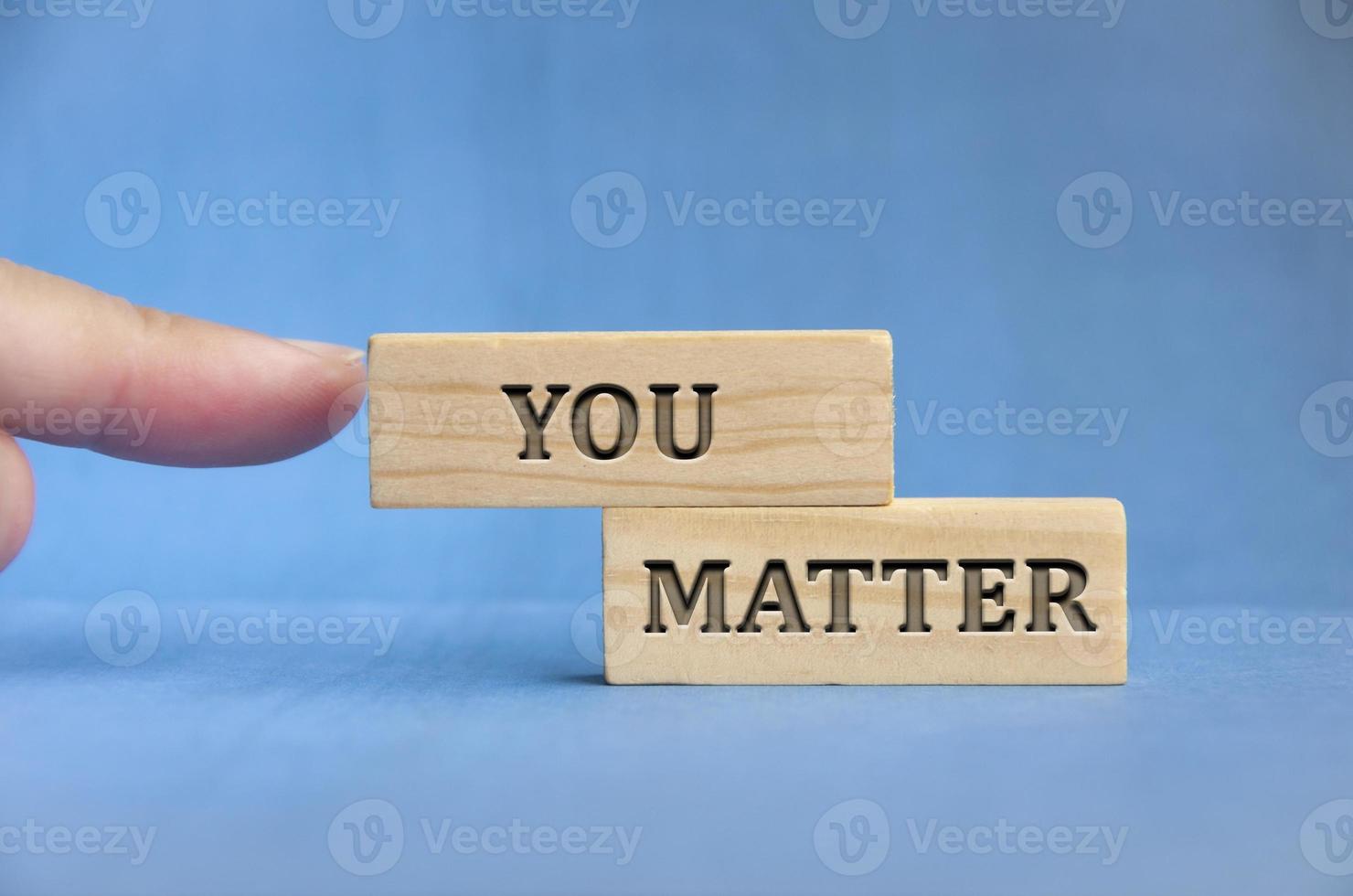 Finger pointing you matter text engraved on wooden block. Inspirational concept photo
