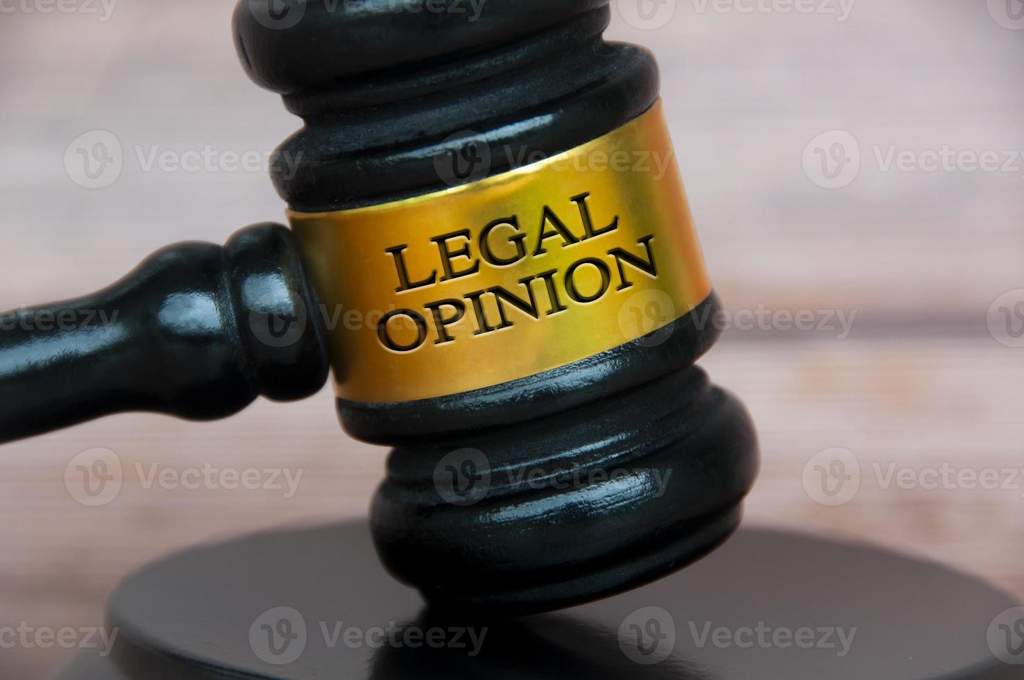 Legal opinion text engraved on lawyer gavel with blurred wooden background. Legal and law concept photo