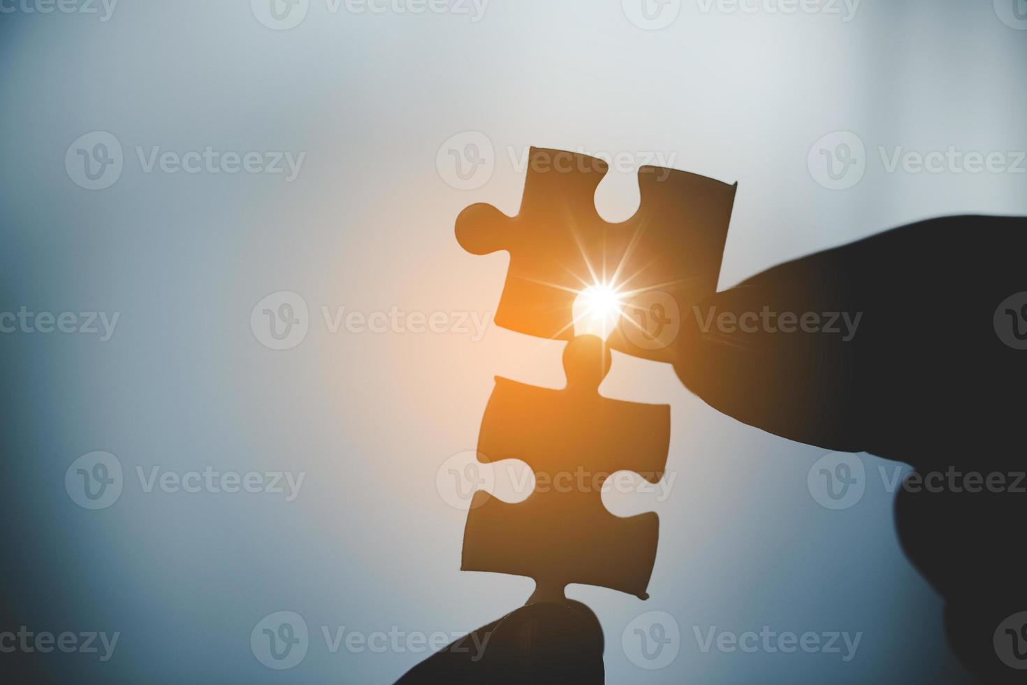 Business woman person hand holding puzzle piece idea for strategy and solution. Closeup part of two white jigsaw connect together. Concept of join cooperation success teamwork-problem corporate team photo