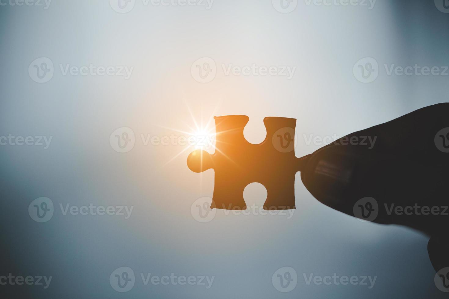 Business woman person hand holding puzzle piece idea for strategy and solution. Closeup part of two white jigsaw connect together. Concept of join cooperation success teamwork-problem corporate team photo