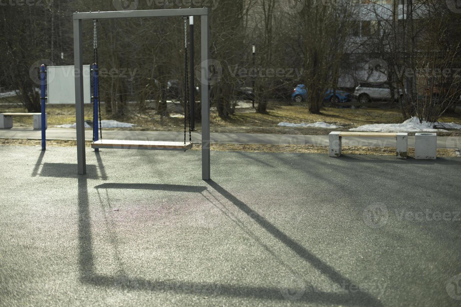 Swing in park. Children's playground. Place to relax. photo