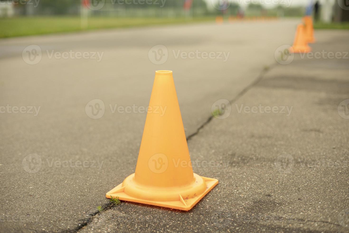 Orange cap on road. Warning sign. photo