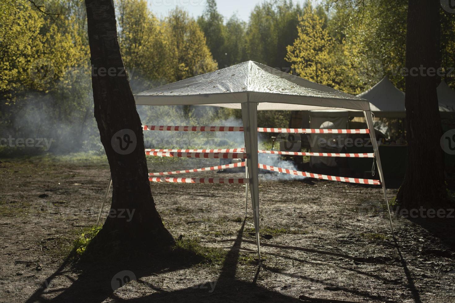 Tent in woods. Fenced camping. photo