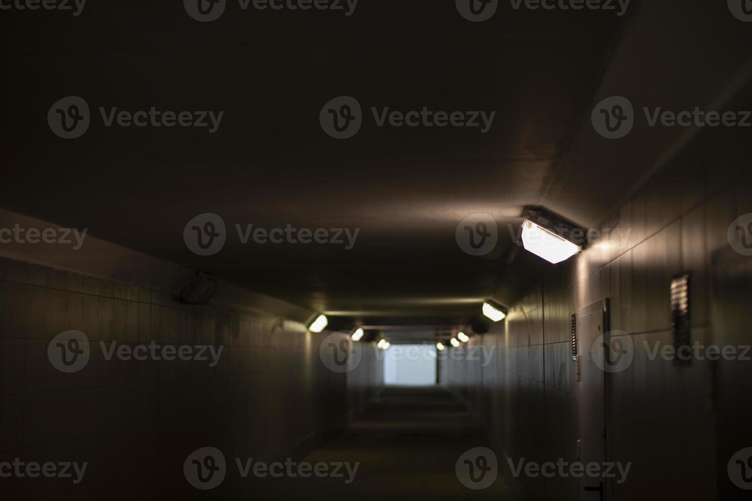 Tunnel with lamps. Architecture of city. Pedestrian crossing under road. photo