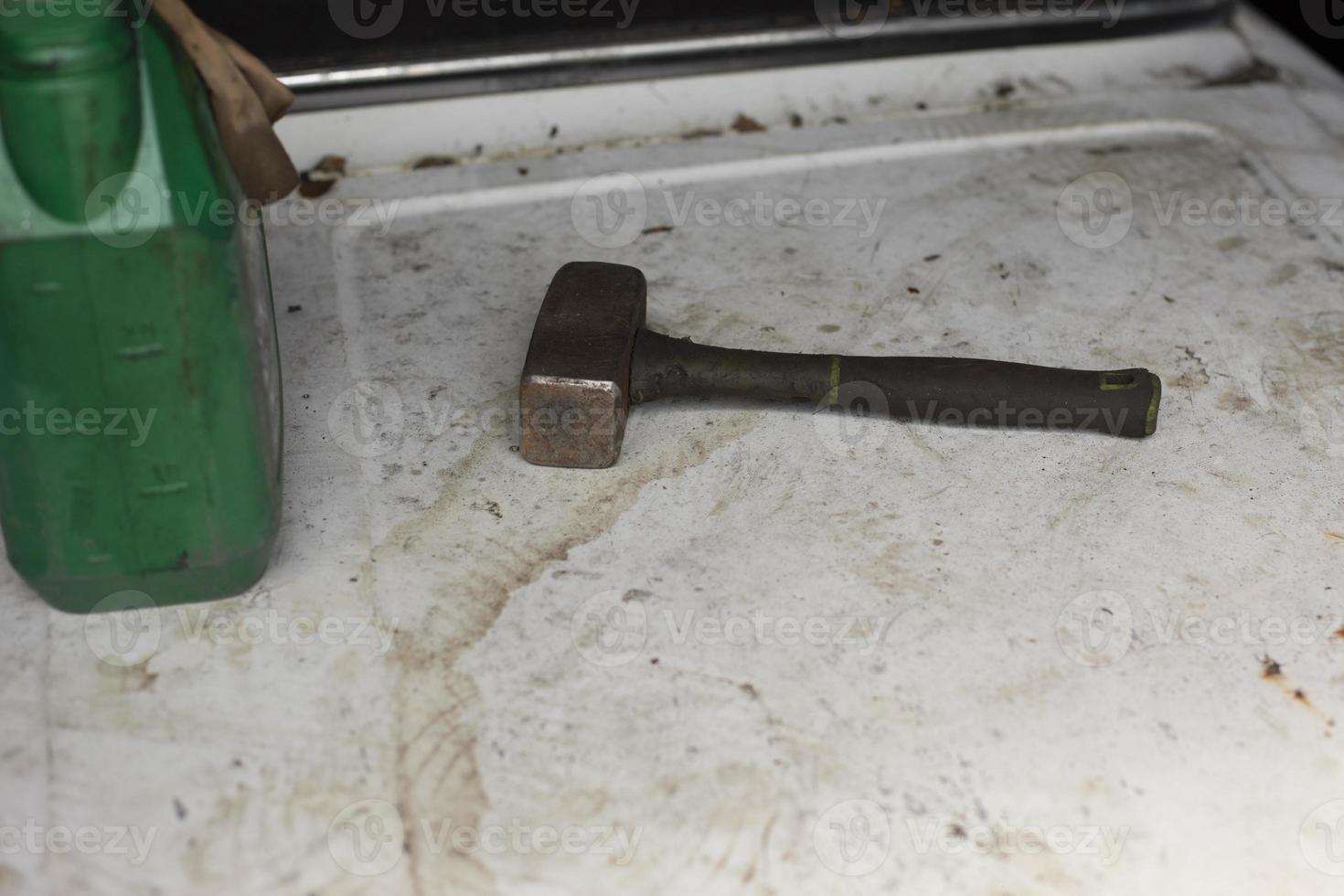 Steel hammer lies on surface. Tool for hammering nails. photo