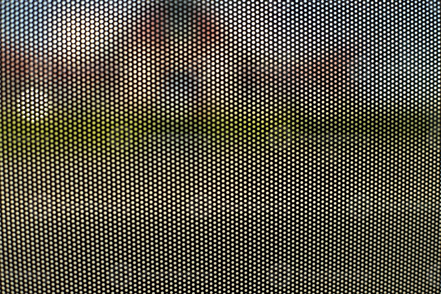 Mesh texture on glass. Shooting window. Small cage. photo