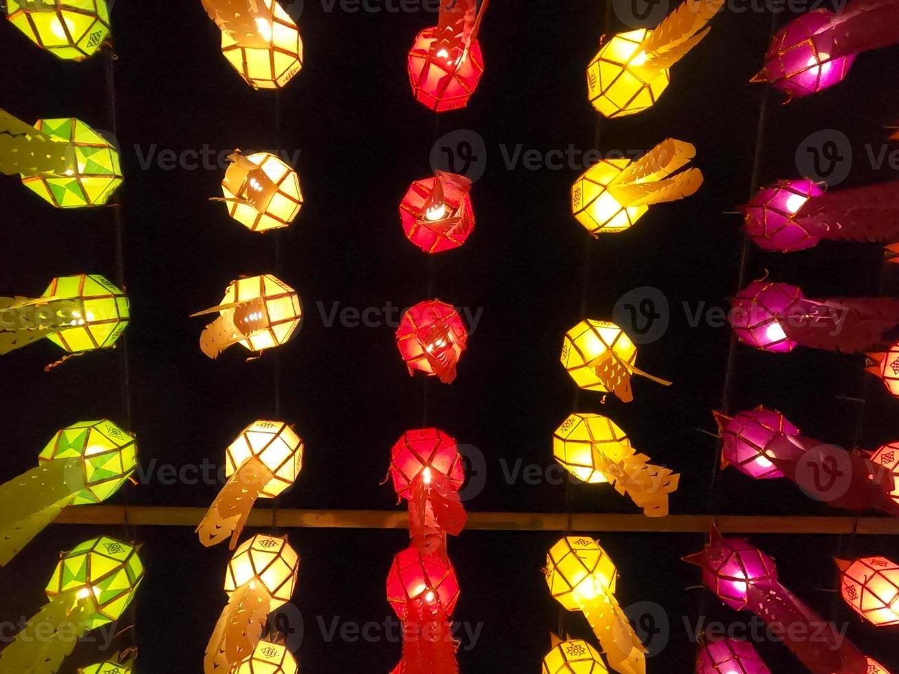 Colorful look up and bottom view of Thai Lanna style lanterns to hang in front of the temple on night time in Loy Kratong Festival. photo