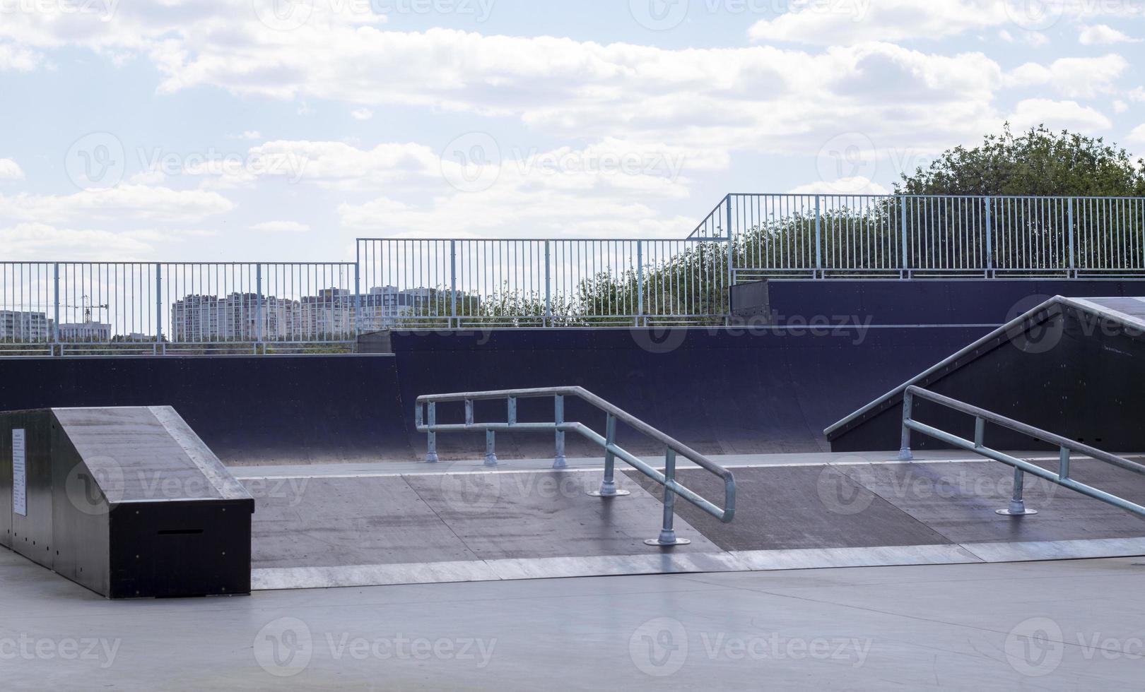 Skate park during the day. Empty, no people skating park. Skatepark ramps. photo