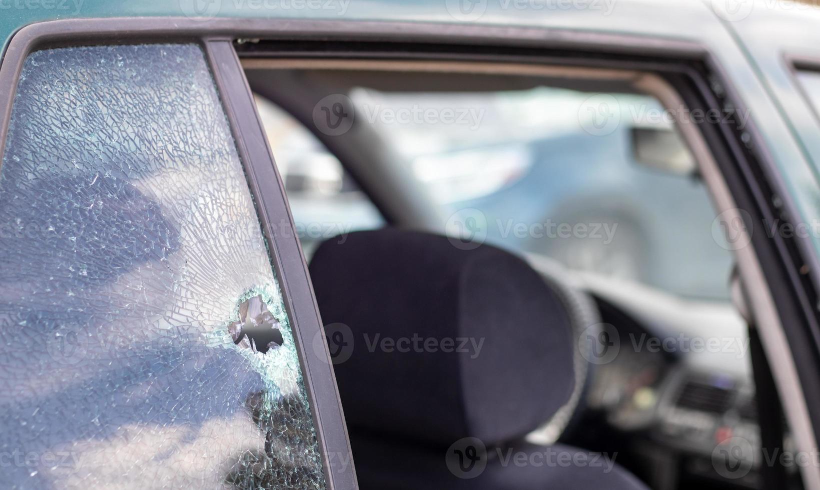 Car riddled with bullets. War of Russia against Ukraine. A car of civilians shot by the Russian military during the evacuation of women and children. Traces of bullets and fragments of shells. photo