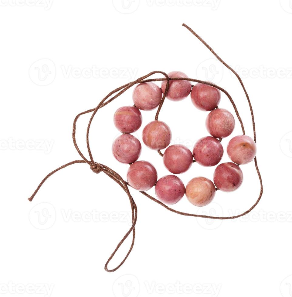 coiled string of beads from pink rhodonite gems photo