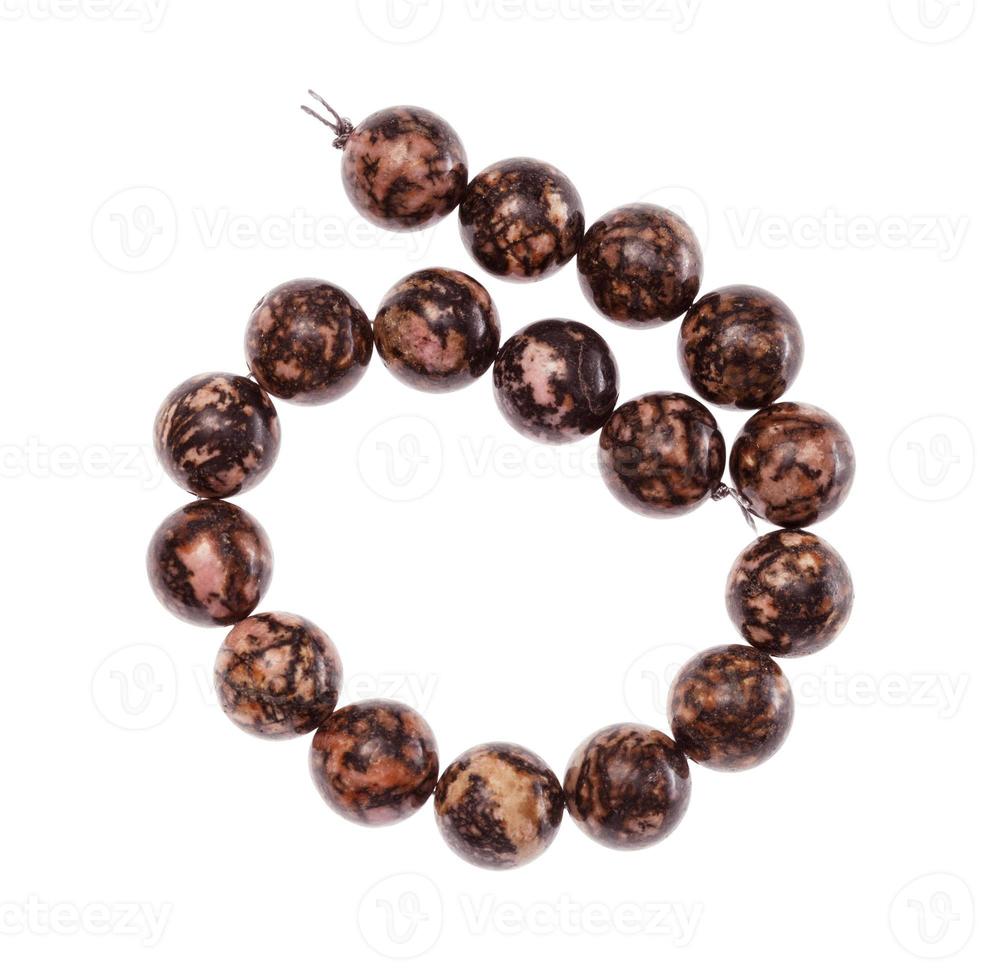 coiled string of beads from rhodonite gemstone photo