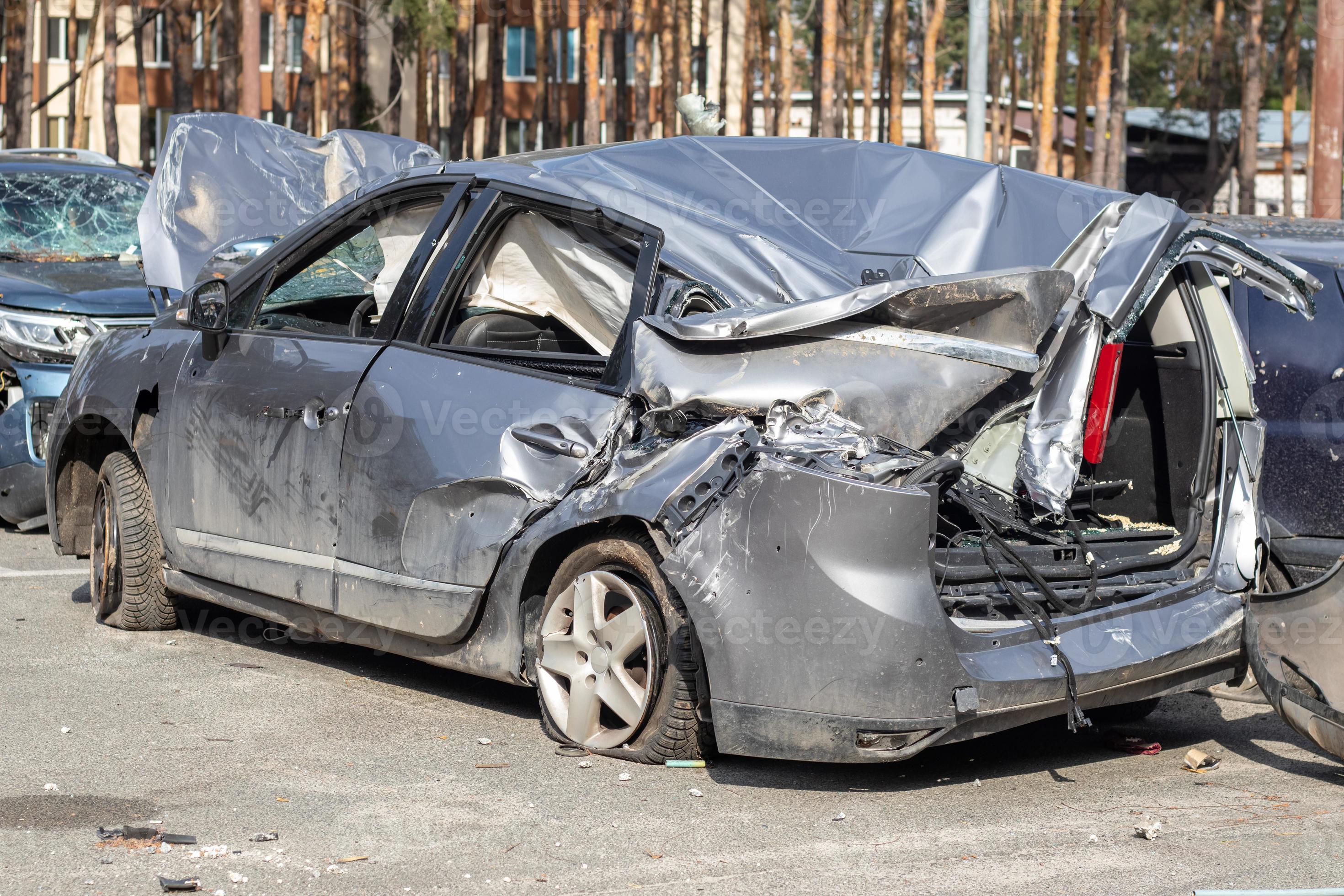 Many broken cars after a traffic accident in the parking lot of a  restoration service station on the street. Car body damage workshop  outdoors. Sale of insurance emergency vehicles at auction. 8281183