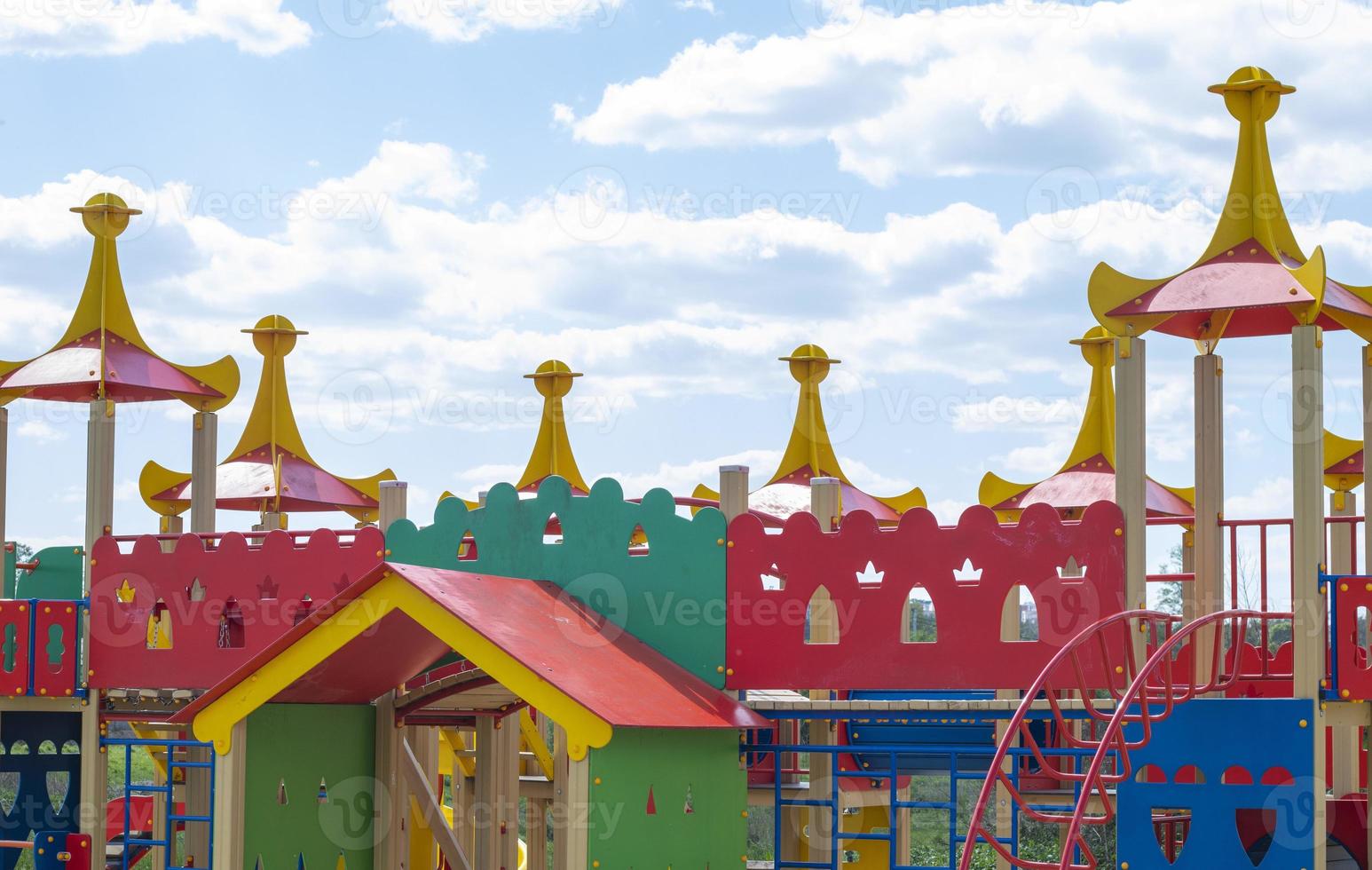 Modern public playground against the blue sky. A colorful play and sports complex for children without people. Equipment for rock climbing and assault on the playground. photo