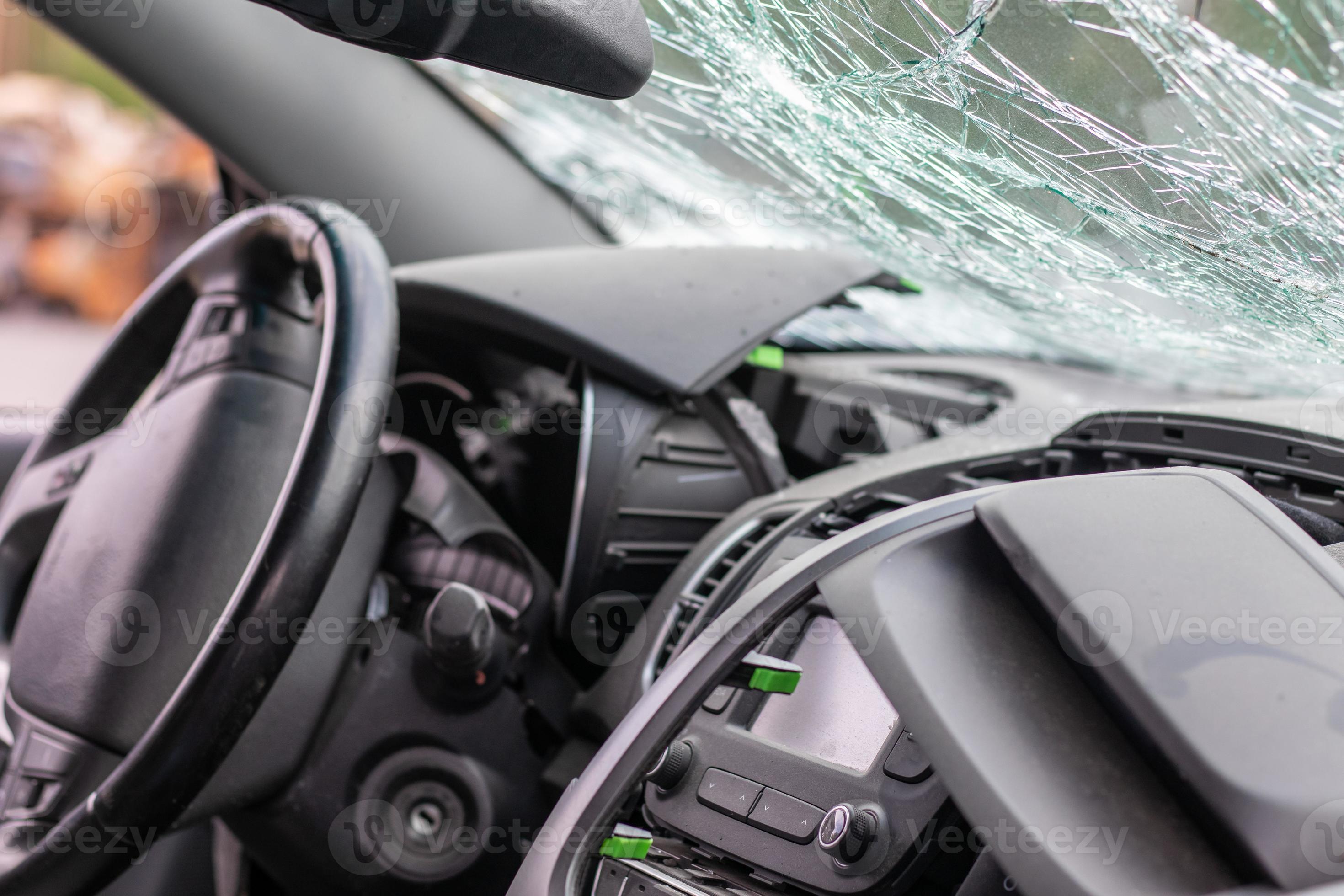 Damaged car window after an accident. Broken windshield as a result of