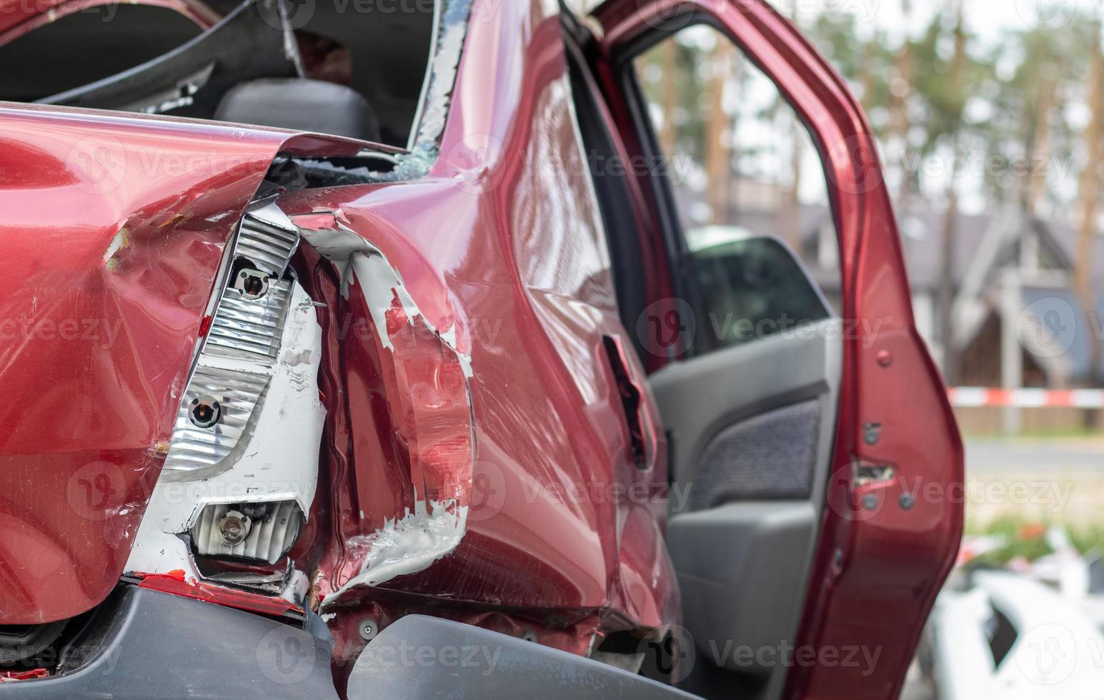 Red car after a terrible accident on the side of the road. Frontal and side impact. Life insurance. An accident without the possibility of recovery. Back view. Damage after an accident. photo