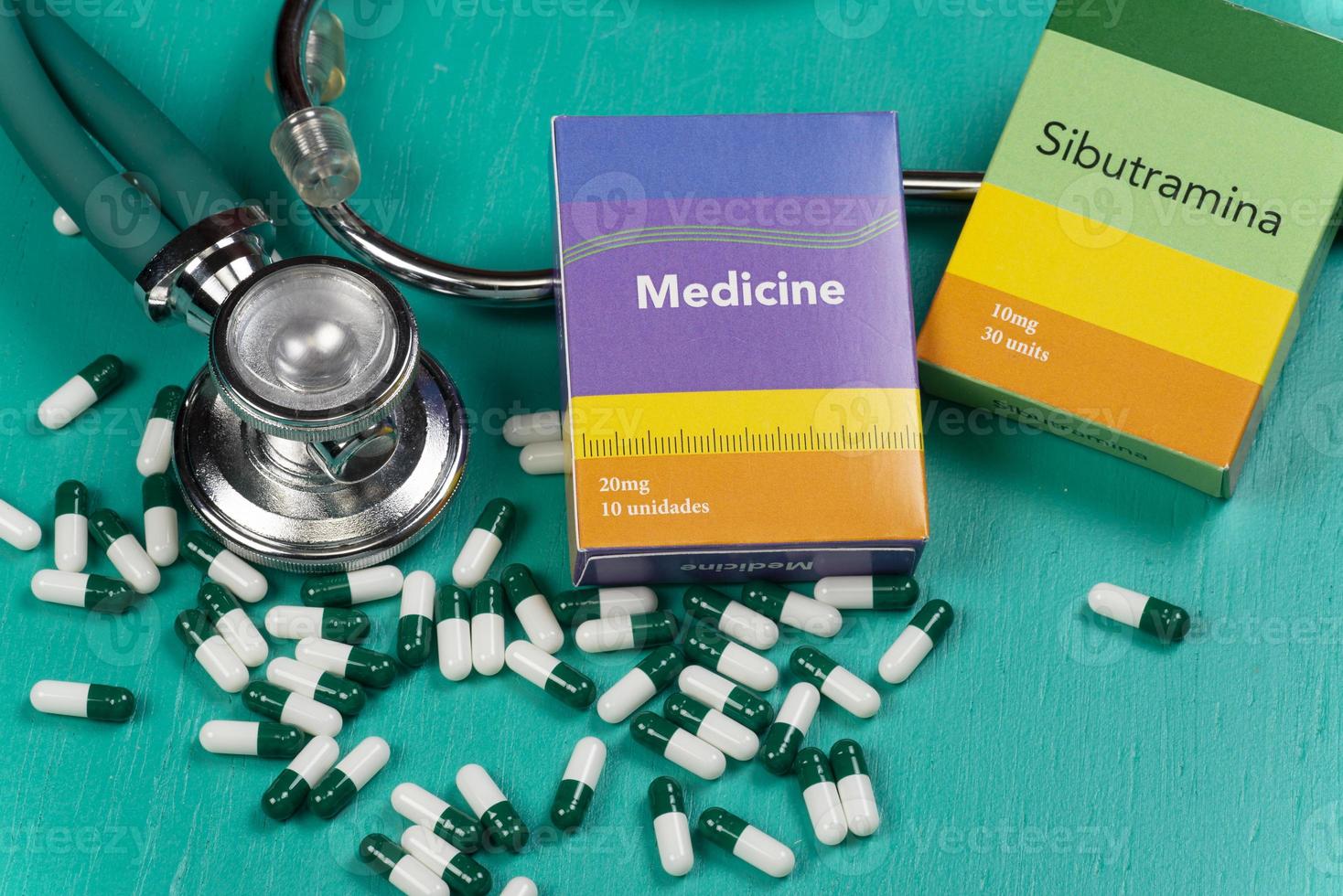 Health care medical and sickness concept. Pills and medical equipment background with a drug box fake write Medicine photo