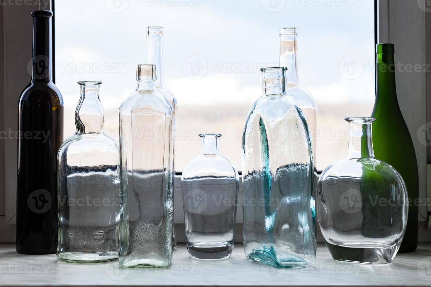 many empty bottles on sill and view of park photo